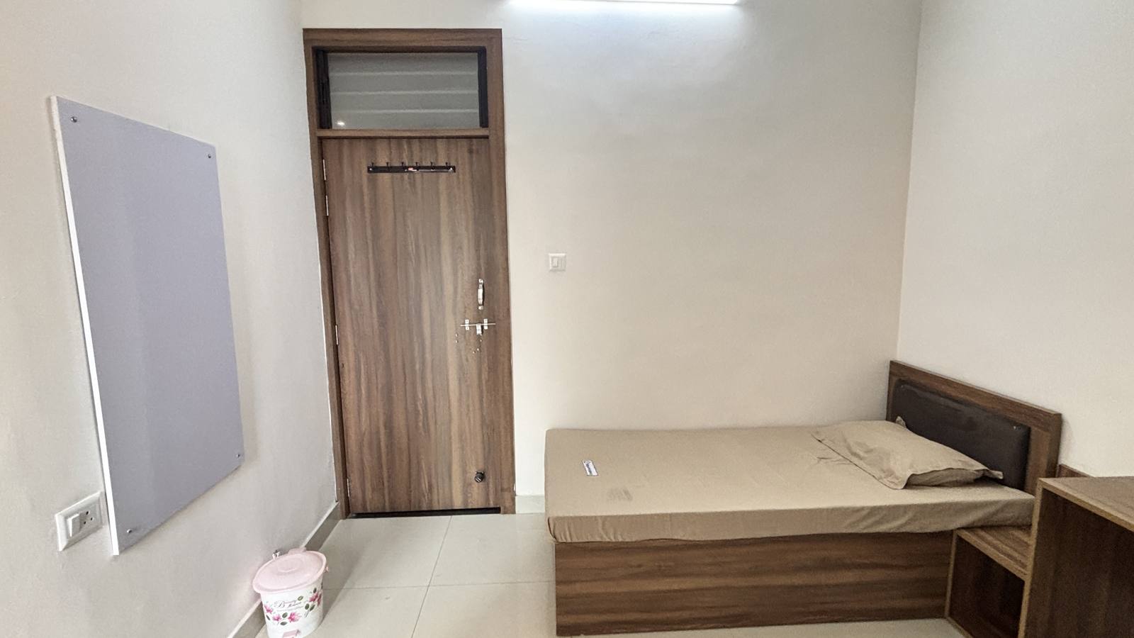 Queen room bed with wardrobe and pin board